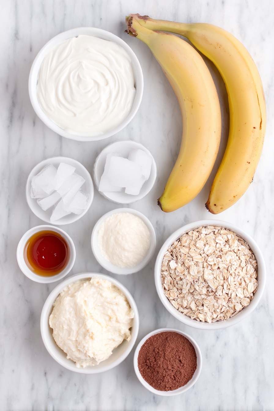 Flat lay of two whole unpeeled bananas, a small white bowl of coconut milk, a small white bowl of creamy vanilla yogurt, a small white bowl filled with old-fashioned oats, a small white bowl of ice cubes, a small white bowl of golden agave syrup, a small white bowl with pale yellow banana cream pudding mix, and a small white bowl containing ground cinnamon, all arranged symmetrically on a clean white marble surface, soft natural light, photo taken with an iPhone, professional food photography style, fresh ingredients, white ceramic bowls, no bottles, no duplicates, no utensils, no packaging --ar 2:3 --v 7 --p m7354615311229779997